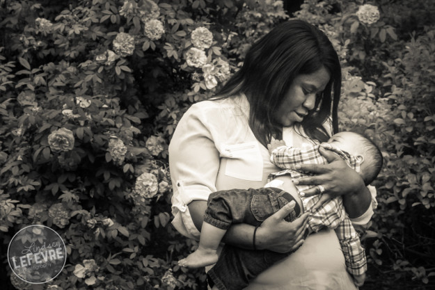 Mother cuddling a baby in the Ricks Gardens by Lindsey LeFevre