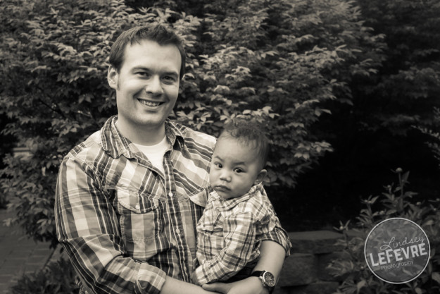 Father holding baby portrait in the Ricks Gardens by Lindsey LeFevre