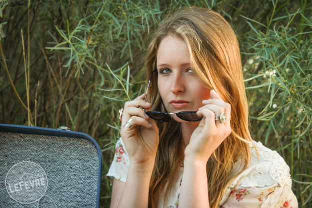 Lindsey LeFevre's women's fashion shoot. Blonde girl peaking over sunglasses.