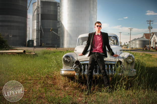 Lindsey LeFevre's men's fashion shoot. Guy in sunglasses leaning against old silver ford car.  