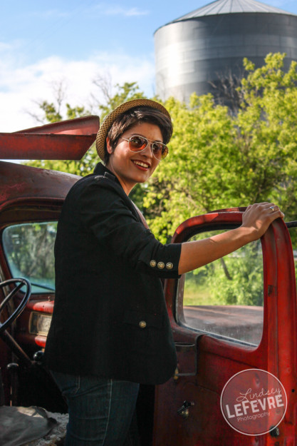 Lindsey LeFevre's women's fashion shoot. Girl wearing sunglasses leaning out of an old ford truck. 