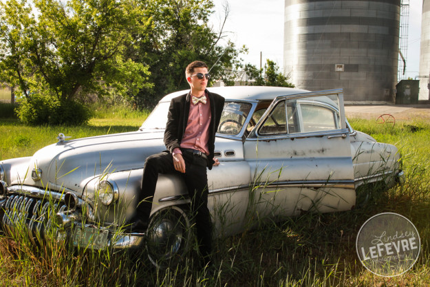 Lindsey LeFevre's men's fashion shoot. Guy in sunglasses leaning against old silver ford car.  