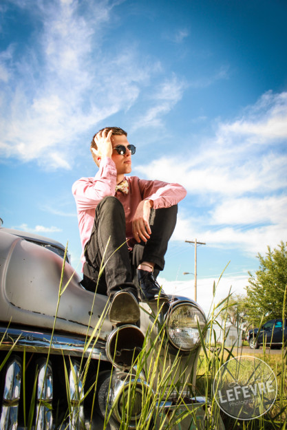 Lindsey LeFevre's men's fashion shoot. Guy sitting on top of old ford car. 