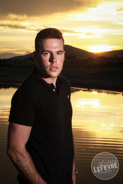 Lindsey LeFevre's men's fashion shoot. Guy standing in the sunset in Egin Lake. 